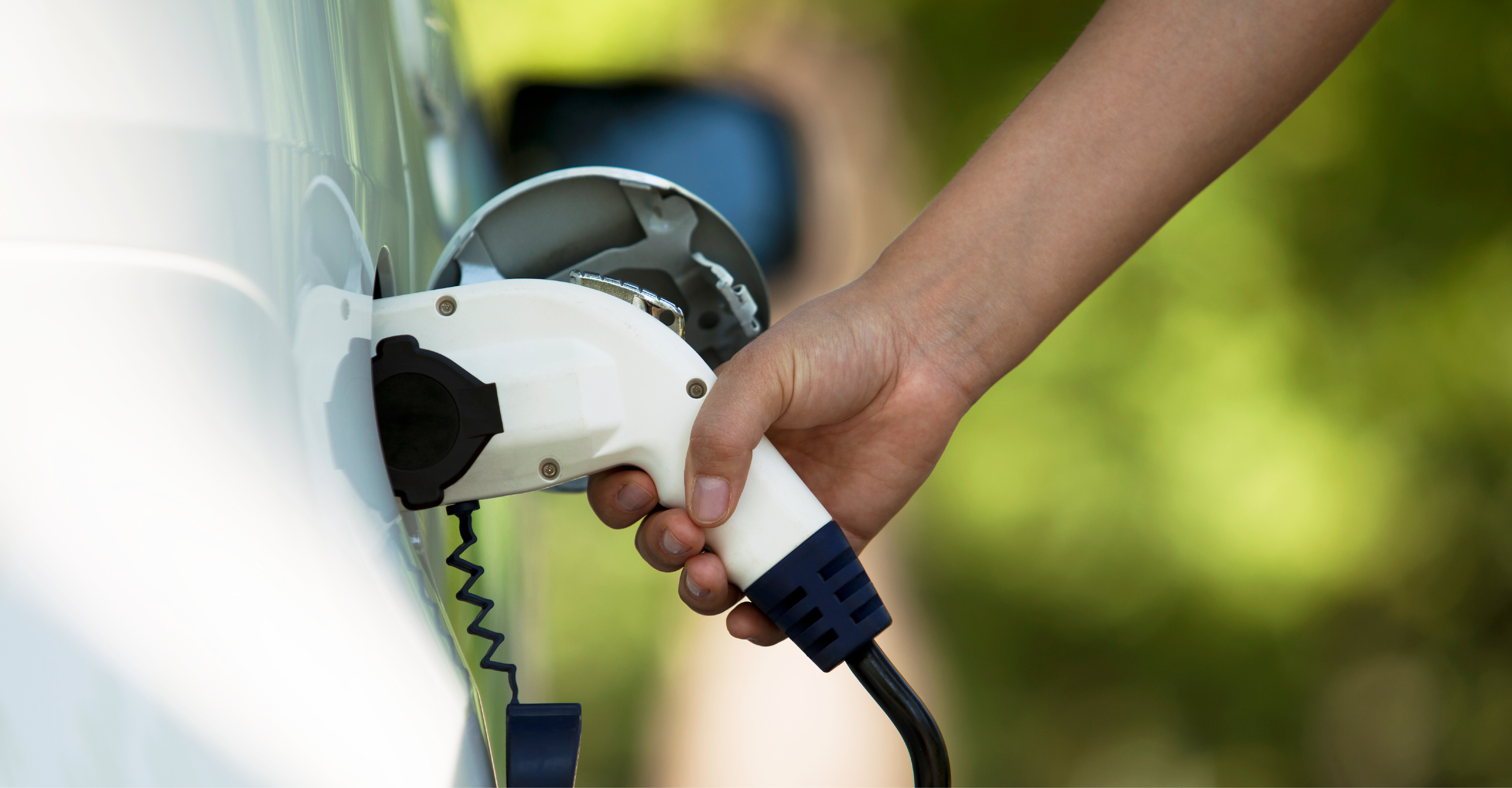 person ev charging a car