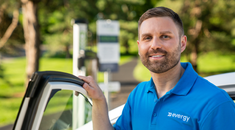 employee standing by and EV charging
