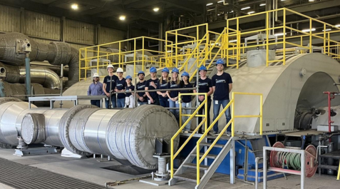 image of Evergy interns gathered near machinery at Jeffery Energy Center