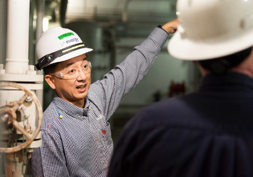 An Evergy worker pointing something out at a plant